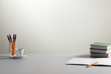 Masanın üzerinde renkli kalem yığını olan kitabı aç