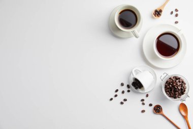 Beyaz arka planda kahve fincanı ve kahve çekirdeği.