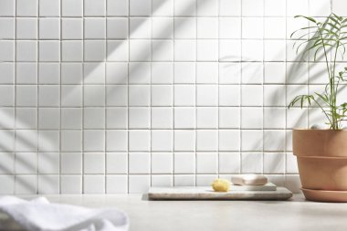 Beyaz seramik zemin üzerinde çeşitli nesneler ve sıcak güneş ışığı içinden geçiyor..