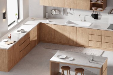 Parlak bej renkli bir mutfak. Pencereden içeri güneş ışığı giriyor..