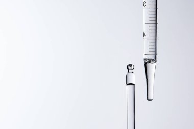 Kozmetik ve tıbbi görüntüler için kullanılabilen bir damlacıktan dökülen temiz sıvı damlacıklar.