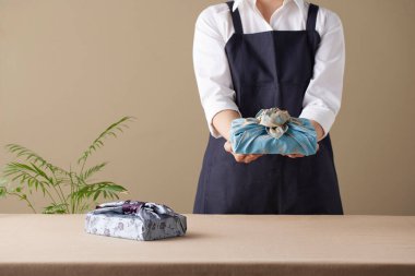 Bojagi (geleneksel Kore kumaşı) kullanan bir kadın. Kore bayramları ve yıldönümleri için yeniden kullanılabilir, el yapımı hediye paketi..