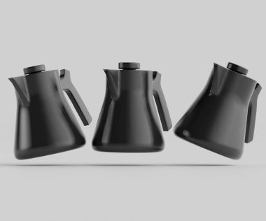 Üç modern siyah çaydanlık ya da kahve demliği açık gri arka planda havada yüzer. Tencereler gösterişli ve basit, minimalist tasarımlara sahip. Işık parlıyor ve tencerelerin pürüzsüz yüzeylerini vurguluyor. Ortam çok güzel.