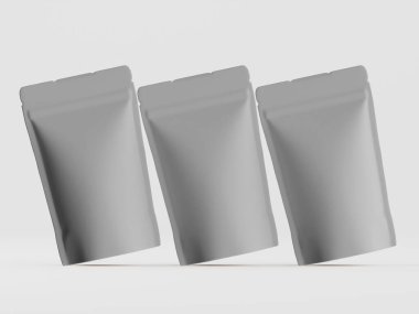 Açık gri arka planda, muhtemelen yiyecek veya içecek için üç gri kese sergilenmektedir. Keseliler basit bir tasarıma sahipler. Biraz katlanmış ve pürüzsüz, düzgün bir yüzeyi var. Işıklandırma nötr, keselerin dokusunu vurguluyor. 