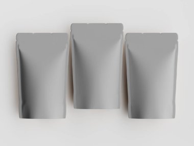 Yiyecek ya da içecek olarak kullanılabilecek üç gri kese, açık arkaplanda yatay olarak dizilmiştir. Keseler pürüzsüz ve esnek bir malzemeden yapılmış gibi görünüyor. Işık, tarafsız arka plan temiz ve basit bir görüntü yaratır. Görüntü... 