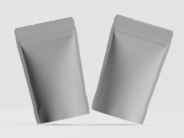 Tarafsız bir arkaplanda iki gri, metalik ambalaj torbası görülüyor. Çantaların parlak, pürüzsüz bir yüzeyi var. Bir şekilde uçtuklarını ya da askıya alındıklarını gösteriyor. Tarafsız bir renk düzeni ile sahne basit. Resimler