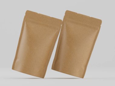 Tarafsız bir arkaplanda iki açık kahverengi kağıt kese sergileniyor. Keseler şekil ve boyut olarak benzerdir, pürüzsüz, mat bir finişe sahiptir. Aydınlatma eşit ve belirgin bir gölge bırakmıyor. Parlak, nötr bir şekilde keseleri gösteriyor.