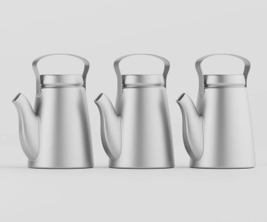 Üç modern, gümüş çaydanlık basit, temiz bir iç mekan ortamında duruyor. Manzara, metalik çaydanlıkların pürüzsüz ve pürüzsüz şekillerini gösteren açık gri arkaplanın doğrudan yukarıdan çekilmiş görüntüsü. Aydınlatma, metalik yüzeyleri vurguluyor. 