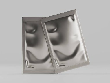 İki gümüş folyo torbası kapalı bir ortamda sunuluyor, muhtemelen stüdyo, boş, parlak, nötr bir arka plan. Pürüzsüzdürler, biraz buruşuk yüzey dokusuyla ve çapraz olarak düzenlenmişlerdir. Işıklandırma eşit ve nötr. 