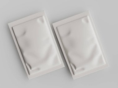 Tarafsız bir arkaplanda, yiyecek veya kişisel bakım ürünleri için olması muhtemel iki beyaz kese veya paket sergileniyor. Dikdörtgenler ve biraz buruşuk, dokulu bir yüzeye sahipler. Görüntü iyi aydınlatılmış ve yüksek açılı bir bakış açısından, bir açıklık sağlıyor.