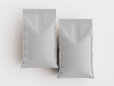 İki açık gri, sade paket torbası sade beyaz arka planda düzenlenir. Çantalar dikdörtgen ve düz, mat bir maddeden yapılmış gibi görünüyor. Tepedeki ışıklandırma çantalarda hiç gölge göstermiyor. Temiz ve basit bir görüntü yaratıyor. Bu resim