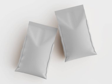 Düz beyaz arka planda iki açık gri paket sergileniyor. Torbaların boyutları ve şekilleri birbirine benzer ve pürüzsüz bir mat yüzeyleri vardır. Tepedeki ışık üniforma ve parlak bir görünüm yaratıyor. Görüntü prodüksiyon için çok uygun.