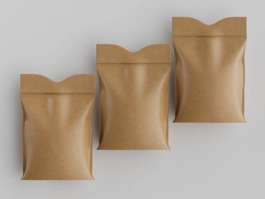 Tarafsız bir arkaplanda üç kahverengi kese kağıdı sıralanarak minimalist bir kompozisyon oluşturulur. Çantalar, katlanmış üstleriyle, bir mat dokusu ve sıcak, doğal bir renk sergiliyor, bu da geri dönüşümlü ya da çevre dostu bir tasarım olduğunu gösteriyor. Lig.