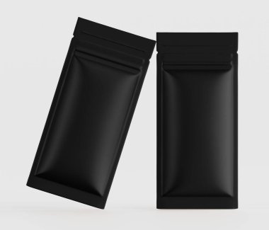 Açık gri arka planda iki siyah, mat, dikdörtgen, folyo kaplı kese sunuluyor. Kese, çeşitli ürünler için uygun, esnek bir ambalaj stili gibi görünüyor. Temiz, basit tasarım ve nötr arkaplan potansiyele izin verir