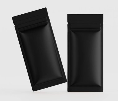 İki siyah, dikdörtgen yiyecek paketleme kesesi yüksek açılı, yukarıdan görülüyor. Keseliler çapraz yönelimli ve açık gri bir zeminde yüzüyormuş gibi görünüyor. Torbaların pürüzsüz, mat bir sonu var. Aydınlatma parlak.