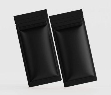 Bir stüdyo ortamında iki siyah folyo kesesi gösteriliyor. Keseler dikdörtgen şeklinde ve yiyecek ya da diğer eşyalar için tasarlanmış gibi görünüyor. Keseler pürüzsüz bir yüzeyi olan siyah bir mat. Üst kenarları mühürlü ve yüzüyor gibiler.