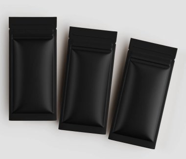 Üç siyah, dikdörtgen, esnek kese düz, açık gri arka plana karşı hafifçe örtüşen bir şekilde düzenlenir. Kese, yumuşak bir maddeden yapılmış gibi görünüyor ve muhtemelen yiyecek paketlemek için kullanılıyor. Görüntü alındı.