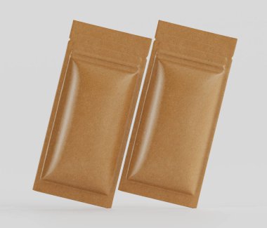 Açık kahverengi, kağıt ya da kartondan yapılmış gibi görünen iki dikdörtgen kese, pürüzsüz, parlak folyo gibi bir kaplama, nötr gri bir zemin üzerinde havada süzülüyor. Keseler stil, boyut ve renk olarak aynı görünüyor. Işıklandırma I 'yı gösteriyor.