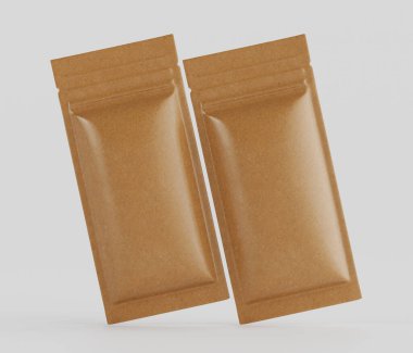 Gıda veya baharat paketleri için muhtemelen kağıt benzeri iki açık kahverengi kese, tarafsız gri arka planda sergilenmektedir. Keseler folyo ya da plastik kapakla mühürlenmiş gibi görünüyor. Keselerin pürüzsüz, hafif parlak bir yüzeyi var. Sunumları