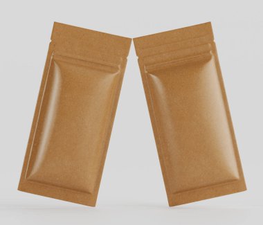 Açık kahverengimsi, dikdörtgen, folyoyla mühürlenmiş iki kese yiyecek ambalajı gibi görünüyor. Keselerin pürüzsüz, hafif parlak bir yüzeyi var. Malzemeler hafif ve esnek bir tasarımı işaret ediyor. Keseler simetri ve hafif bir uzaklığa yerleştirilmiş.