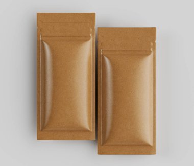 Açık kahverengi, dikdörtgen, folyo kesesi yüksek açılı, stüdyo çekimleri tarafsız gri arka planda. Keselerin pürüzsüz, hafif parlak bir yüzeyi ve hafifçe içe göçük bir şekli var. Aydınlatma eşit, önemli bir şey değil.