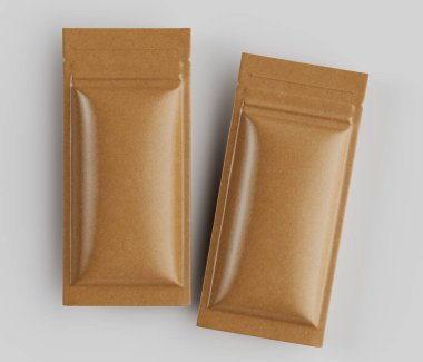 İki açık kahverengi, dikdörtgen, yeniden mühürlenebilir çanta, şekil ve boyut olarak benzer, yatay, üst üste binen bir düzende düzenlenmiştir. Kese yiyecek paketleme için tasarlanmış gibi görünüyor. Atıştırmalık ya da baharat gibi. Malzemeler mat ve pürüzsüz görünüyor.