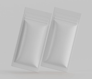 İki boş, açık gri, esnek ambalaj kesesi düz beyaz arka planda yüzer. Keseler dikdörtgen şeklinde ve pürüzsüz bir kaplaması var. Çapraz yönelimlidirler ve izleyiciden hafifçe açılı olarak konumlandırılmışlardır. Resim bir kullanıcıName 