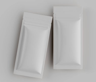 İki dikdörtgen, beyaz, esnek kese açık gri bir yüzey üzerinde düz konur. Kese parlak bir maddeden yapılmış gibi görünüyor. Hafif çakışan bir konuma yönelmiş durumdalar, bu da gıda ürünleri için ambalaj öneriyor. Işıklar eşit.