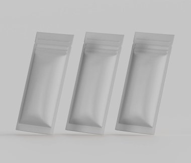 Üç açık gri, dikdörtgen keseler ya da ambalajlar üç boyutlu bir resimde sergilenmektedir. Kese pürüzsüz, mat bir malzemeden yapılmış gibi görünüyor ve fermuarı ya da yeniden mühürlenebilir bir kapağı var. Keseler dinamik bir sunumla açılandırılmış, bir his yaratıyor.