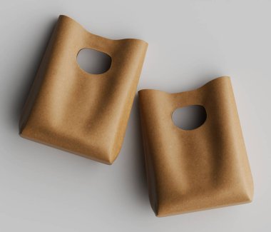 Yukarıdan iki açık bej renkli, basit çanta gösteriliyor. Çantalar pürüzsüz, süslenmemiş bir yüzeye sahip ve sapları için kesikleri var. Aydınlatma eşit, belirgin bir gölge bırakmıyor ve çantaların tarafsız rengini vurguluyor. Çantalar yerleştirildi.