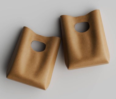 İki açık bej, sade, dikdörtgen çanta tarafsız bir arkaplan karşısında bir stüdyo ortamında sergilenir. Çantalar pürüzsüz, deri gibi bir doku ve kesik saplı farklı bir tasarım sergiliyor. Aydınlatma eşit, belirgin bir gölge bırakmıyor.. 