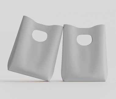 Açık gri renkli iki poşet, açık gri arka planda sergileniyor. Poşetler, şekillerini ve potansiyel kullanımlarını gösteren hafif çapraz bir sunumla yönlendiriliyor. Çantaların sade, yuvarlak şekilleri ve sapları için kesikleri var.