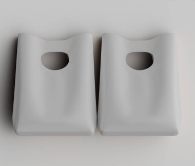 Açık gri, sade, dikdörtgen çantalar açık gri bir arkaplanda sergileniyor. Çantalar pürüzsüz ve esnek bir malzemeden yapılmış gibi görünüyor. Her çantada kolay erişim için dairesel bir delik var. Çantalar simetrik olarak düzenlenmiş.