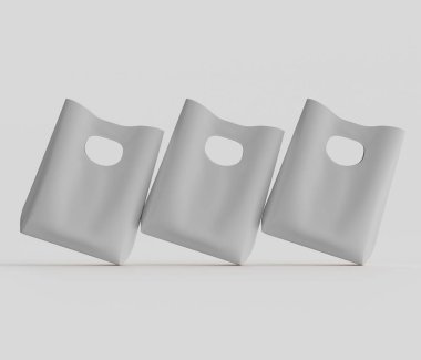 Üç adet açık gri plastik alışveriş torbası 3 boyutlu olarak sunuluyor. Çantalar çapraz ve dinamik bir düzende yerleştirilmiş. Çantalar düz, nötr bir renk ve basit bir tasarım gösteriyor. Torbaların yüzey dokusu pürüzsüz görünüyor.
