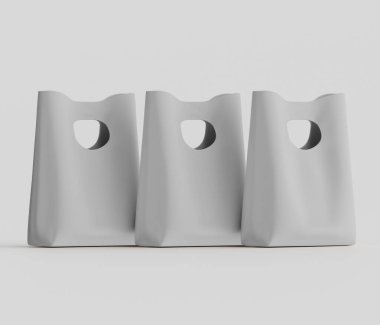 Tarafsız bir arkaplanda yatay sırada üç açık gri alışveriş torbası sıralanır. Çantalar basit, dikdörtgen ve pürüzsüz bir kaplama. İkisinin de kesik saplı bir tasarımı var. Işıklandırma eşit ve nötr.