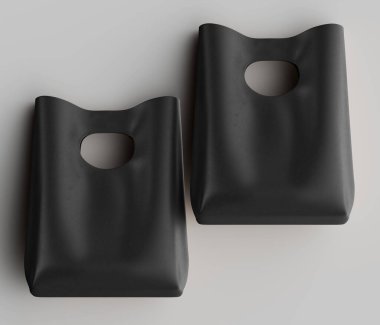 İki özdeş koyu renkli nesne tarafsız bir arkaplanda sunuluyor. Objelerin üst kısmında açık bir kapı kolu var ve şekli bir kap ya da torba olduğunu gösteriyor. Işıklandırma yumuşak ve dağınık görünüyor, S 'yi tanımlayan ince gölgeler.