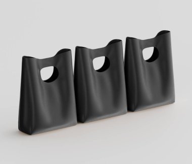 Üç tane minimalist, koyu renkli çanta parlak, tarafsız bir arkaplan karşısında yerleştirilmiş. Bu da stüdyo ortamını işaret ediyor. Poşetlerde temiz, modern bir estetik sergileniyor. Basit bir kesme sapı var. Torbaların pürüzsüz yüzeyi çevreyi yansıtıyor. 