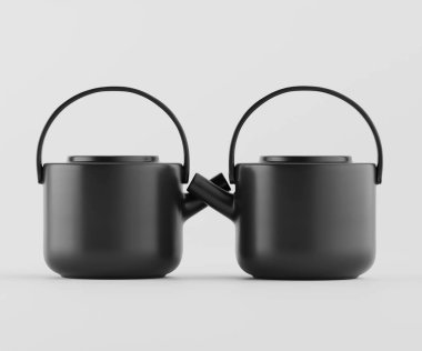 İki özdeş siyah çaydanlık düz beyaz bir zemine karşı sunuluyor. Tencereler yuvarlak şekilli ve aynı kulplarla modern. Işıklandırma, tencerelerin pürüzsüz, mat yüzeyinin altını çiziyor. Bileşimi simetri.