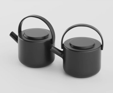 İki modern, mat siyah çaydanlık, açık gri arka planda bir stüdyo çekiminde yer alır. Çaydanlıklar yuvarlak ve basit ve temiz çizgileri var. Her birinin dairesel bir kapağı ve eline rahatça sığacak şekilde biçimlendirilmiş bir sapı var. Th