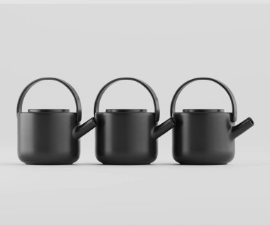 Üç modern, mat siyah çaydanlık açık gri arka planda bir stüdyo ortamında sergilenir. Çaydanlıkların basit yuvarlak şekilleri vardır ve yatay bir sırada dizilmişlerdir. Aydınlatma düz ve parlak, pürüzsüz yüzeyleri vurguluyor ve m