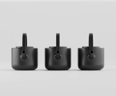 Üç modern, mat siyah çaydanlık ya da kahve demliği tarafsız bir zemine karşı bir sırada dizilir. Çömlekler geometrik şekilli ve pürüzsüz, katı bir maddeden yapılmış gibi görünüyor. Minimalist stil, süs eşyası eksikliği ile vurgulanır.