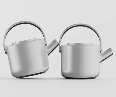 İki modern çaydanlık bir stüdyo ortamında sade bir arka planda sunuluyor. Pürüzsüz kıvrımları, nötr gri rengi ve kendine özgü sapları olan minimalist bir tasarımı vardır. Tencereler biraz ayrı konumlanmış, bu da resmin sana ait olabileceğini gösteriyor.