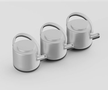 Üç modern, açık gri çaydanlık düz ve nötr bir zemine karşı yatay sırada dizilmiştir. Çaydanlıklar pürüzsüz, yuvarlak şekilleri ve basit sapları var. Aydınlatma bile göze çarpan gölgeler bırakmıyor. Temiz, stüdyo benzeri bir şey yaratıyor.