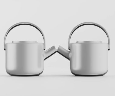 İki modern, açık gri çaydanlık sade ve tarafsız bir zemine karşı yan yana duruyor. Çaydanlıklar pürüzsüz, yuvarlak şekilli, çağdaş bir tasarım sergiliyor. Tencerelerin tutacakları, ağızları ve minimalist bir tabanı var. Işıklar eşit.