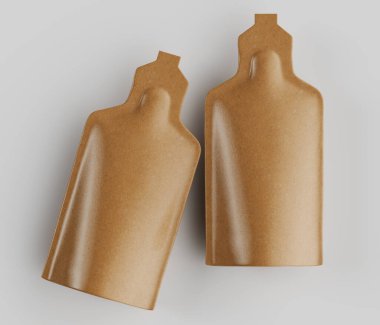 İki bej kesesi, basit beyaz bir arkaplanda sergileniyor. Kesesinde yuvarlak, uzun bir gövde, belirgin bir hortum ve sıvı ya da yarı sıvı içeriği gösteren pürüzsüz, yansıtıcı bir yüzey bulunur. Işık yumuşak ve dağınık görünüyor.