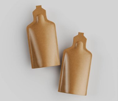 Açık kahverengi, pürüzsüz, dikdörtgen keseler genel bir perspektiften gösteriliyor. Keselerin farklı bir şişe şekli var ve yüzeyleri parlak, hafif yansıtıcı bir son sergiliyor. Işık pürüzsüz ve parlak, keseyi aydınlatıyor.