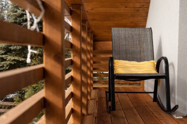Furniture on the balcony in a cabin in the forest