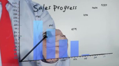 Businessman drawing on glass sales progress indicator