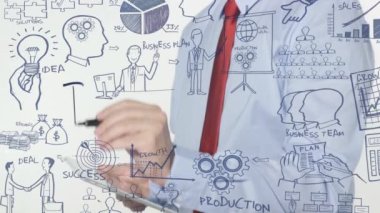 Businessman writing on glass teamwork