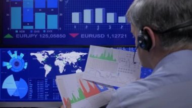 Trader looking data on screens online